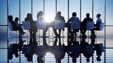 a group of people sitting around a table