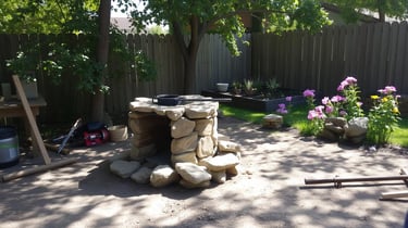 rustic backyard with rocket stove made with large rocks