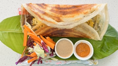 Masala dosa filled with spiced potato, served fresh at Aroha Dosas