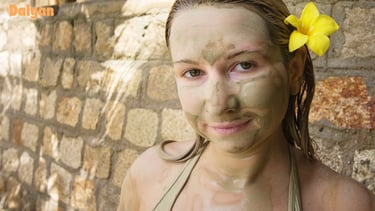 Mud bathing woman with a flower in her hair