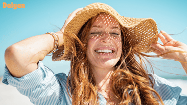 a woman with long hair and a hat on