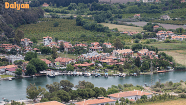 a small town with a river and a boat in the water