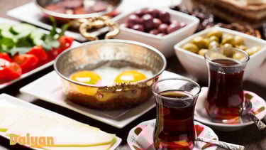 turkish breakfast with eggs and a glass of tea
