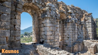 a stone wall with a mountain in the background