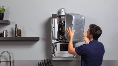a man is fixing a refrigerator in a kitchen