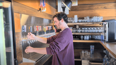 Hunter of Lost Province Brewing tapping a pint of beer