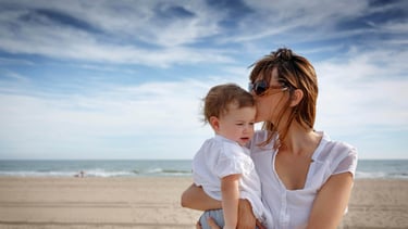 Expat family enjoying beach life in Spain protected by comprehensive life insurance