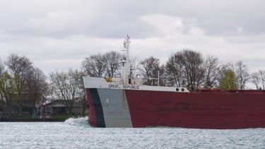 The bow section of the freighter Great Republic. A red ship with black and gray bow stripes.