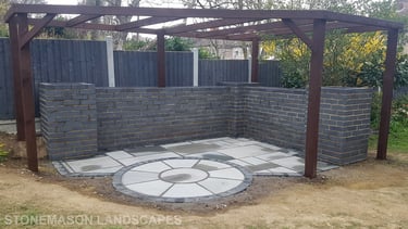 Blue Perforated Brick Wall Planter With Grey Sandstone Circle & Patio Paving & Wooden Pergola