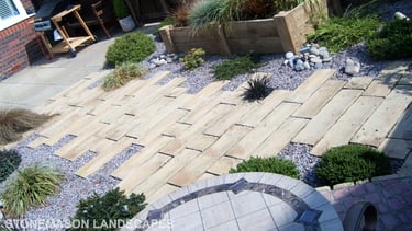Rustic driftwood beach effect small garden with water feature
