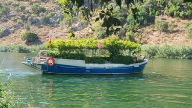 a boat covered with flowers in Dalyan River, one of the best places to visit in Dalyan