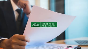 Saudi Food Registration Logo Overlaid, Consultant reviewing SFDA documents.