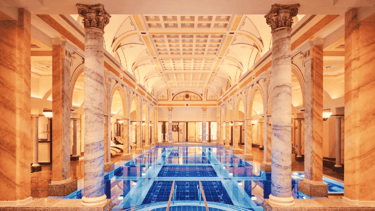 wellness hotel with a large indoor swimming pool with a blue tiled floor