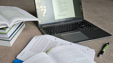 laptop with books on the floor
