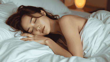 a woman is sleeping in a bed with her eyes closed