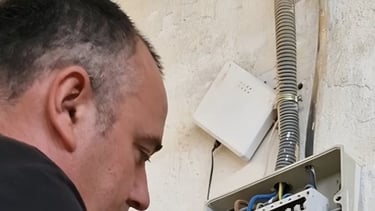 a man in a green shirt is holding a piece of wood