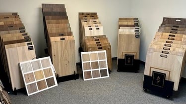Showroom with a variety of hardwood flooring, prefinished hardwood flooring, LVP, and carpet options