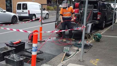 plumber unblocking stormwater pipes