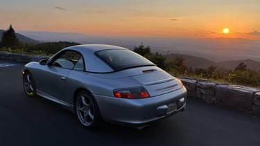 A Porsche 911 in front of a nice sunset