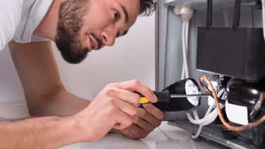 a man in a white shirt is looking at a computer screen
