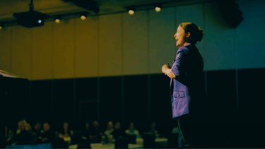 Fun Motivational Speaker Evelina Bereni on stage