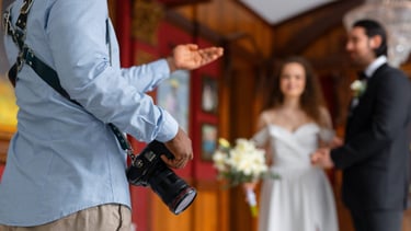a man in a suit and tie is holding a camera