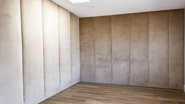 Elegant suede wall panels in neutral tones with wood flooring, custom-designed for a private theater room by Solo Home Decor.