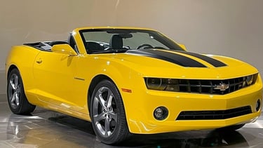 a yellow convertible car with a black and white background