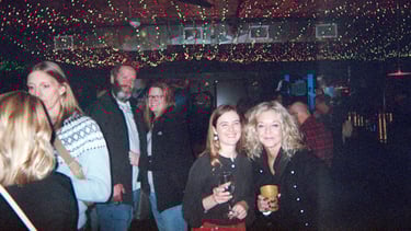 People posing with their drinks in a crowd