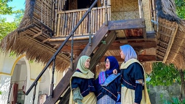 a group of women in traditional dress clothes standing in front of a thatched house in sade village