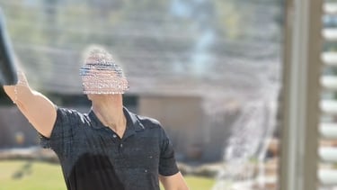 man washing a home window