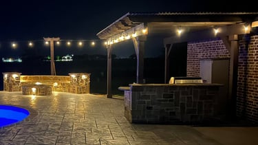 Outdoor Living Space at Night with Pool