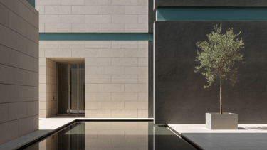 Modern minimalist courtyard featuring a reflecting pool, limestone walls, and an olive tree.