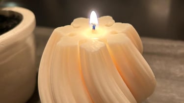 White twisted candles lit over a grey board