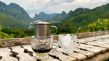 a coffee potted on a table with a cup of coffee