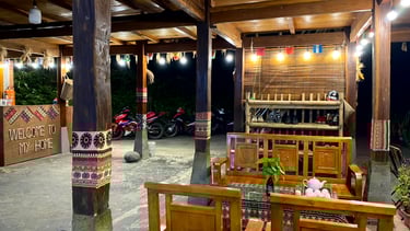 a homestay with a wooden table and chairs