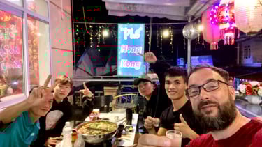 a group of people sitting at a table with food