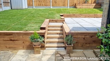 Sleeper Retaining Walls, Planters & Steps With Grey Sandstone Patio & Lawn