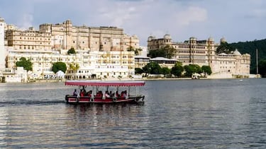 Boat ride on Lake Pichhola with City Palace Udaipur in the background.