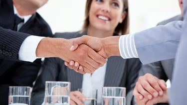 a business meeting with a handshake of two people