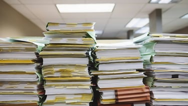 a stack of papers and papers on a desk