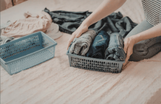 folded clothing organized into storage bin using simple sorting system