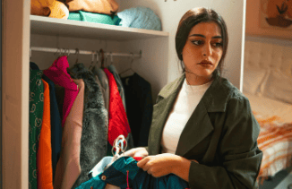 overwhelmed homeowner unsure how to start decluttering a closet