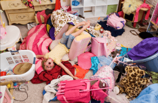 overwhelmed child in cluttered bedroom showing need for home decluttering