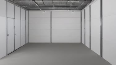 Spacious indoor storage hall with a large motorhome parked inside.