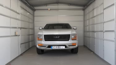 Boat securely stored inside a well-lit, monitored warehouse.