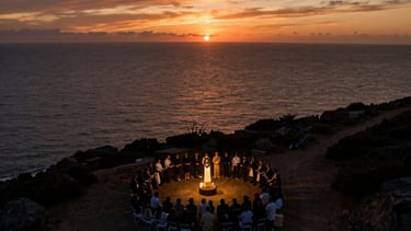 A drone's perspective of a coastal ceremony at sunset. The lighting is cinematic with deep oranges and charcoal blacks, showing a wide, emotional landscape. Professional photography.