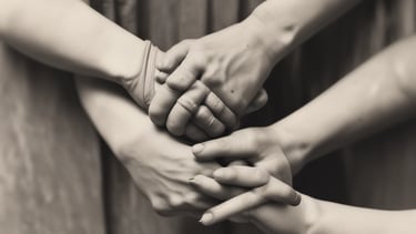 Hands holding a guidebook and a cup of coffee on a minimalist desk