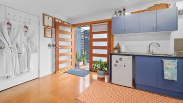 View of the cosy Artist Studio room at Marché Nude Stay with French doors opening to the kitchenette. 