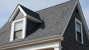 Low angle photography of a newly installed dark charcoal shingle roof on a traditional New York City residential building, bright white trim accents, professional craftsmanship, sharp focus, clear daylight, North American / New York City.